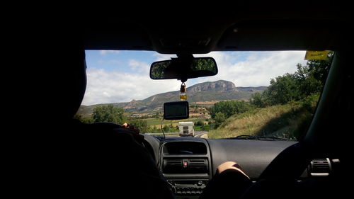 Reflection of car on side-view mirror
