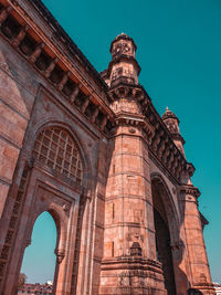 Low angle view of historical building against blue sky