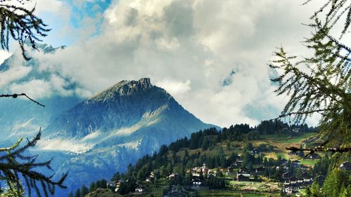 Scenic view of mountains against cloudy sky