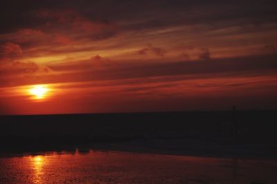 Scenic view of sea against orange sky