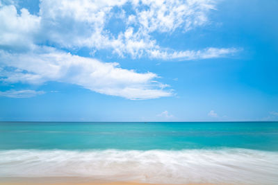 Seascape of soft wave in tropical sea and sandy beach blue cloud sky. 