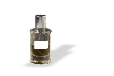 Close-up of glass bottle against white background