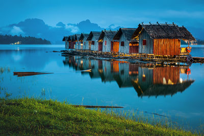 Scenic view of lake by buildings against sky