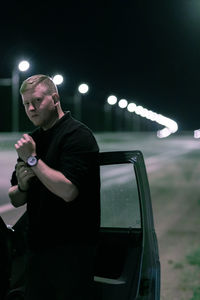 Rear view of man photographing while sitting in car