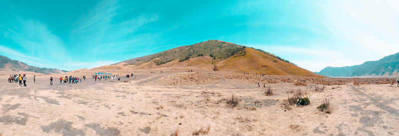 Scenic view of desert against cloudy sky