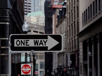 Close-up of road signs in city