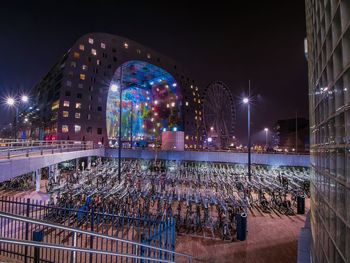 High angle view of bicycles parked by rotterdam centraal station at night