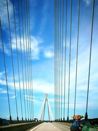 View of suspension bridge against cloudy sky