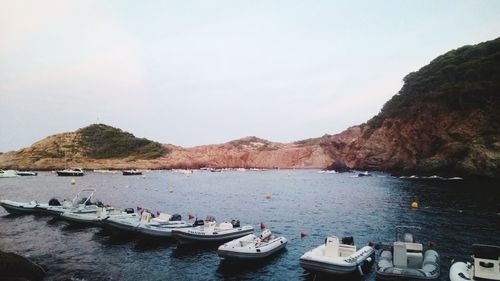 Scenic view of sea and mountains against sky