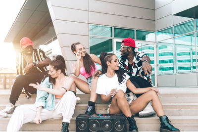 Group of people sitting in front of building