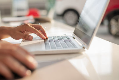 Midsection of man using mobile phone on table