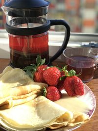 Close-up of strawberries in glass container on table