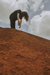 Side view of man standing on sand