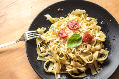 Close-up of served pesto pasta on plate