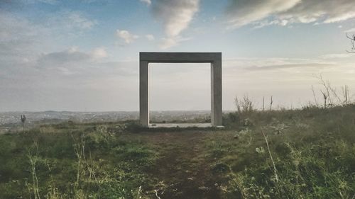 Scenic view of landscape against cloudy sky