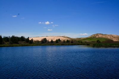 Scenic view of lake against blue sky