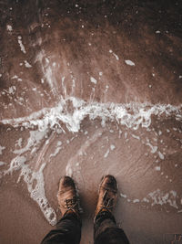 Low section of man standing in water