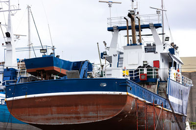 Boats moored at harbor