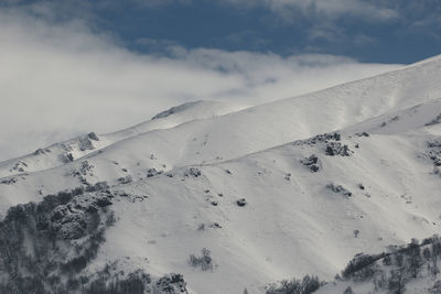 Scenic view of snow covered mountains against sky