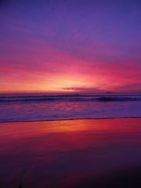 Scenic view of sea against dramatic sky during sunset