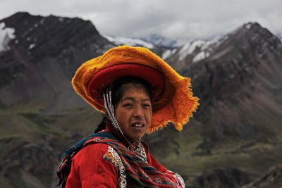 Portrait of smiling woman standing in mountains