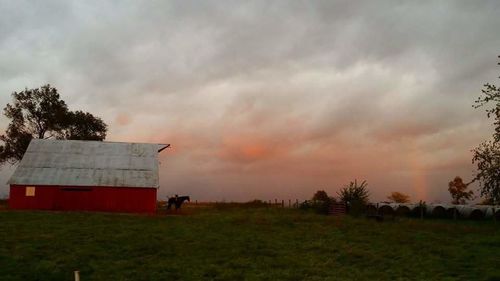 Scenic view of field against cloudy sky