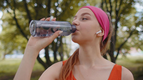 Close-up of woman drinking water