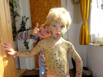 When siblings play - sister paint on body from brother