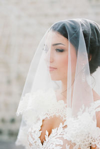 Close-up of young woman wearing wedding dress