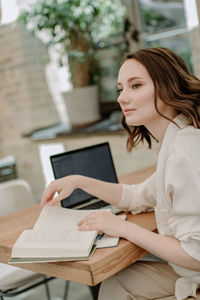 Woman using smart phone on table