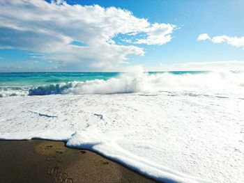 Scenic view of sea against cloudy sky