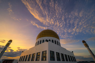 Low angle view of dome against cloudy sky during sunset