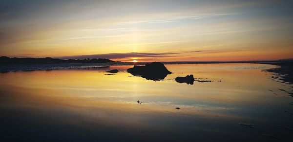 Scenic view of sea against sky during sunset