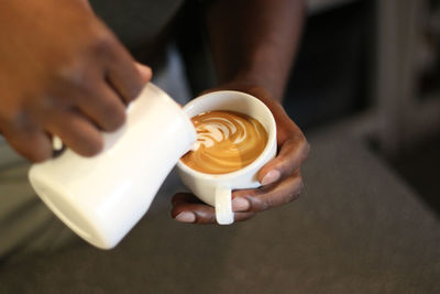 Close-up of hand holding coffee cup