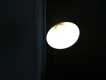 Close-up of illuminated light bulb in the dark