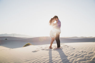 Side view of smiling couple at desert