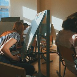 Rear view of people sitting on chair at home