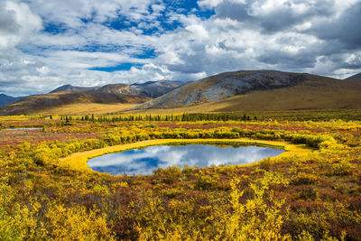 Scenic view of lake and mountains against sky