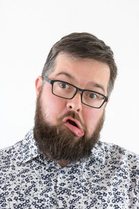 Close-up portrait of young man against white background