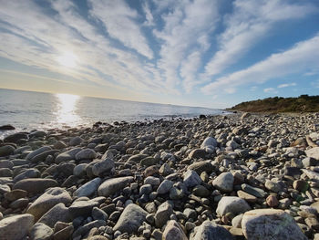 Rocks on beach against sky