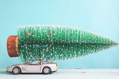 Toy car on table against blue background