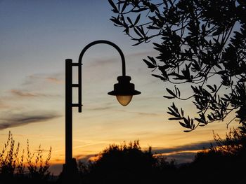 Low angle view of street light against sky at sunset