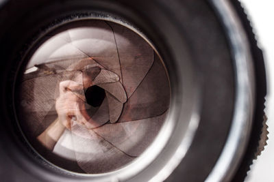 Reflection of man photographing in mirror