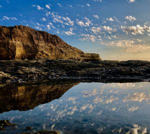 Rock formations in sea against sky