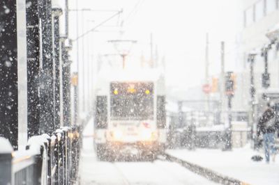 Blurred motion of train on street in city during winter