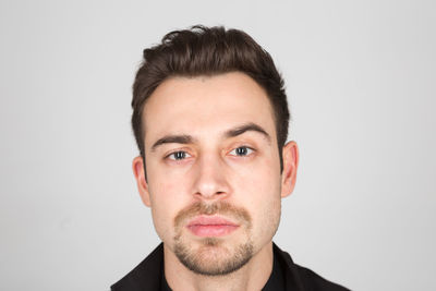 Portrait of young man against white background