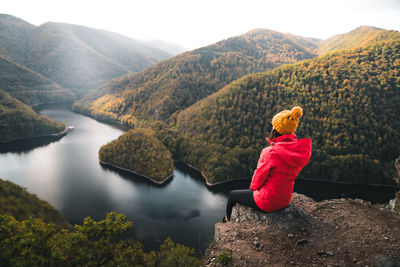 Rear view of woman looking at lake