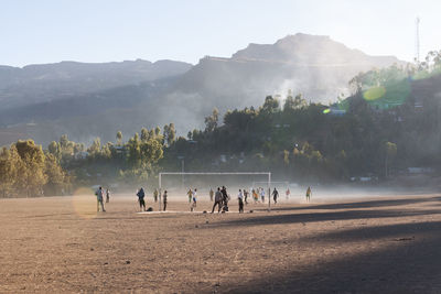 People enjoying in mountains against clear sky