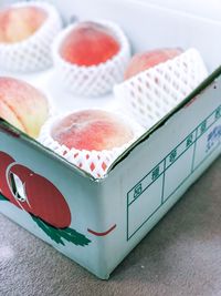 High angle view of fruits in box on table.