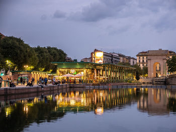 Reflection of buildings in lake at night